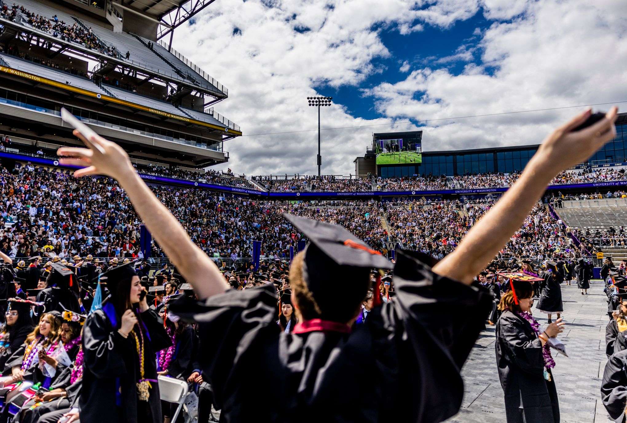 UW graduates celebrating at Husky Stadium commencement ceremony 2026